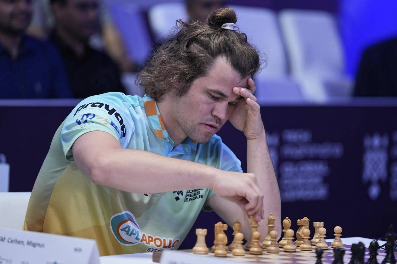 FILE - Norwegian Magnus Carlsen of SG Alpine Warriors plays against Poland’s Jan-Krzysztof Duda of Chingari Gulf Titans during Global Chess League in Dubai United Arab Emirates, on July 1, 2023. The world’s top chess federation on Monday has ruled that transgender women cannot compete in its official events for women until an assessment of gender change is made by its officials. Word of the decision comes as the federation is hosting a World Cup event in Azerbaijan, where top players including No. 1-ranked Grand Master Magnus Carlsen of Norway were attending. (AP Photo/Kamran Jebreili, File)