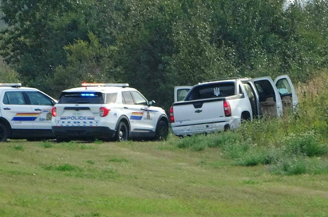 Police and investigators are seen at the side of a road outside Rosthern, Sask., on Wednesday, Sept. 7, 2022. A specialized RCMP team that deals with high-risk situations was not immediately available to respond to a stabbing rampage and hunt for a mass killer in Saskatchewan because of contract negotiations, internal emails show. THE CANADIAN PRESS/Kelly Geraldine Malone