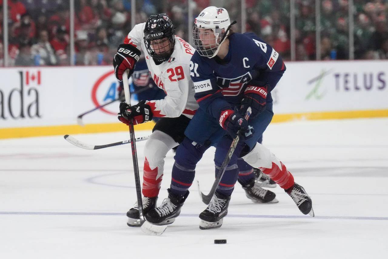 The PWHL, slated to begin play in January, represents a seismic shift in the women’s game, which has provided some of the sport’s iconic moments at the Olympics and world championships with the heated Canada-U.S. rivalry, but has struggled to gain traction in North America with a financially sustainable pro model. USA forward Hilary Knight (21) and Canada forward Marie-Philip Poulin (29) battle during second period IHF Women’s World Hockey Championship gold medal hockey action in Brampton, Ont., on Sunday, April 16, 2023. THE CANADIAN PRESS/Nathan Denette