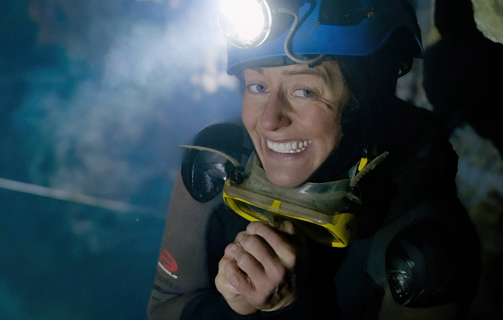 Lead caver Katie Graham and team beat their depth record in Bisaro Anima cave while filming the documentary Subterranean. Here, Graham stands beside an underground pool of water deep in Bisaro Anima Cave, which took the team two days to reach (courtesy of Subterranean film)