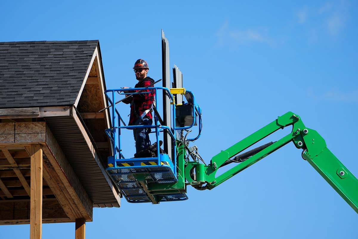 Starting in the new year, B.C. employers will be required to cooperate in a worker’s timely and safe return to work after an injury. A construction worker works from a lift in a new housing development in Ottawa on Friday, Oct. 14, 2022. THE CANADIAN PRESS/Sean Kilpatrick