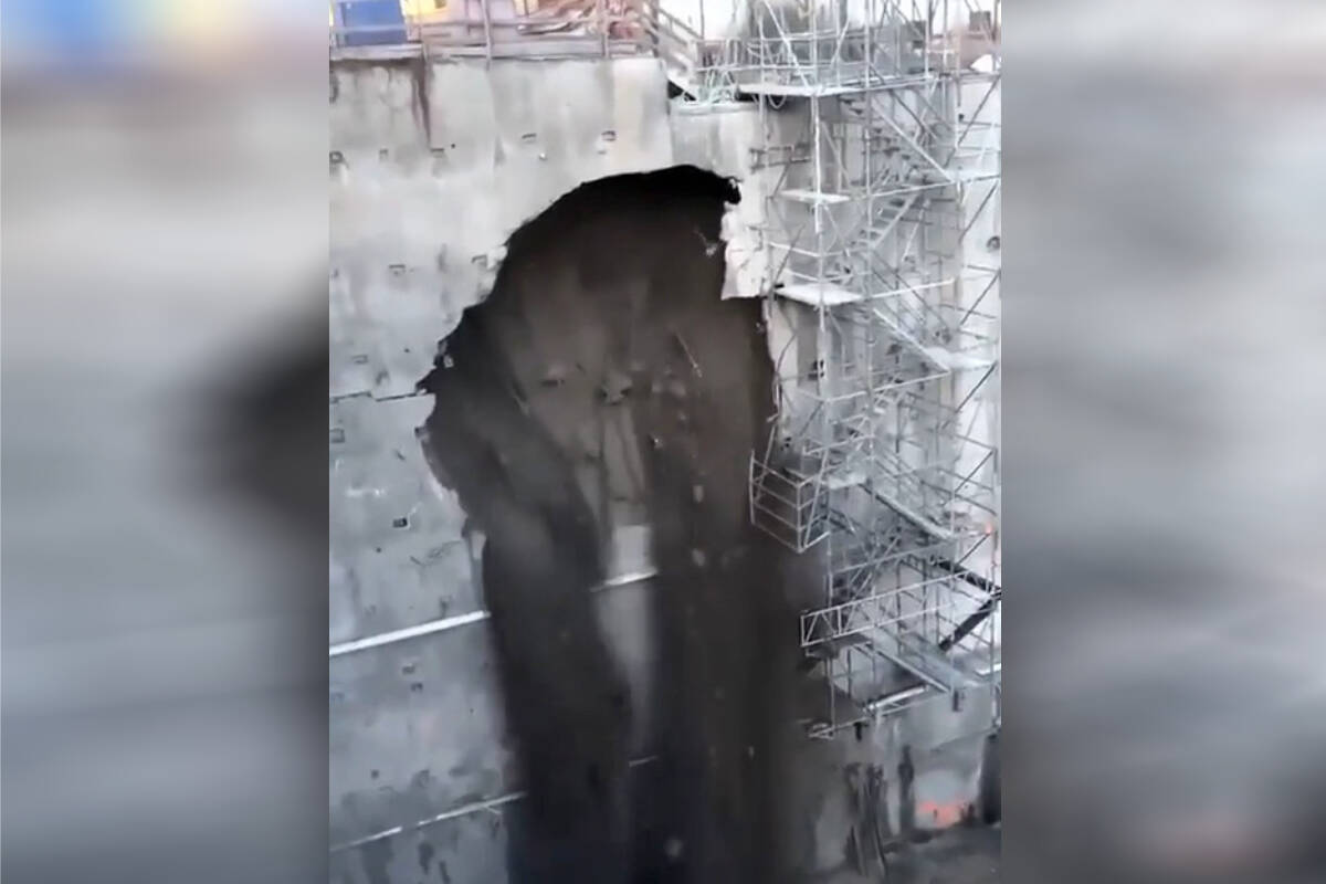 Video captured near Foster Avenue and North Road in Coquitlam shows a construction site retaining wall cracking open and spilling dirt into the foundation on Nov. 29, 2023. (@ashsharma75/X)