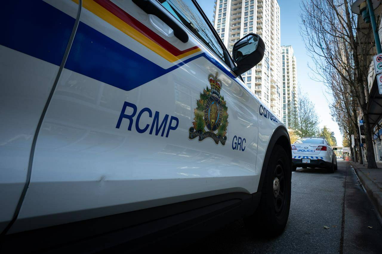 A RCMP vehicle in a road block is seen on Glen Drive after a shooting involving RCMP officers in Coquitlam B.C. on Friday, September 22, 2023. Police in Coquitlam, B.C., are asking for the public’s help in identifying two separate drivers suspected of hitting the same pedestrian in alleged hit-and-run crashes. THE CANADIAN PRESS/Ethan Cairns