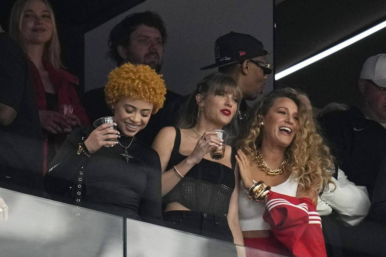 Taylor Swift, center, watches the teams before the NFL Super Bowl 58 football game between the San Francisco 49ers and the Kansas City Chiefs with Ice Spice and Blake Lively on Sunday, Feb. 11, 2024, in Las Vegas. (AP Photo/Ashley Landis)