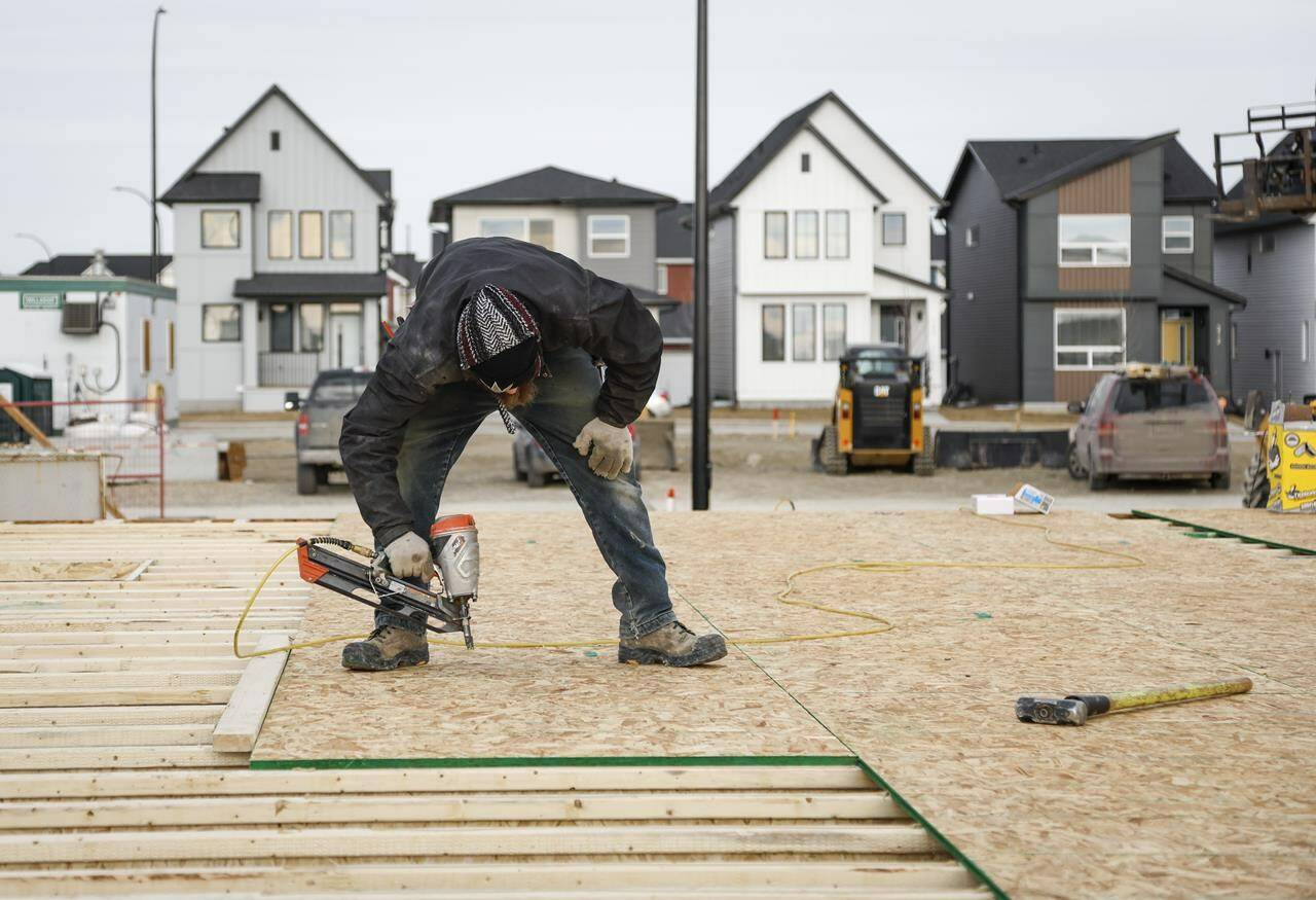 Canada Mortgage and Housing Corp. says the annual pace of housing starts in January fell 10 per cent compared with December. Framers work on a new house under construction in Airdrie, Alta., Friday, Jan. 28, 2022.THE CANADIAN PRESS/Jeff McIntosh