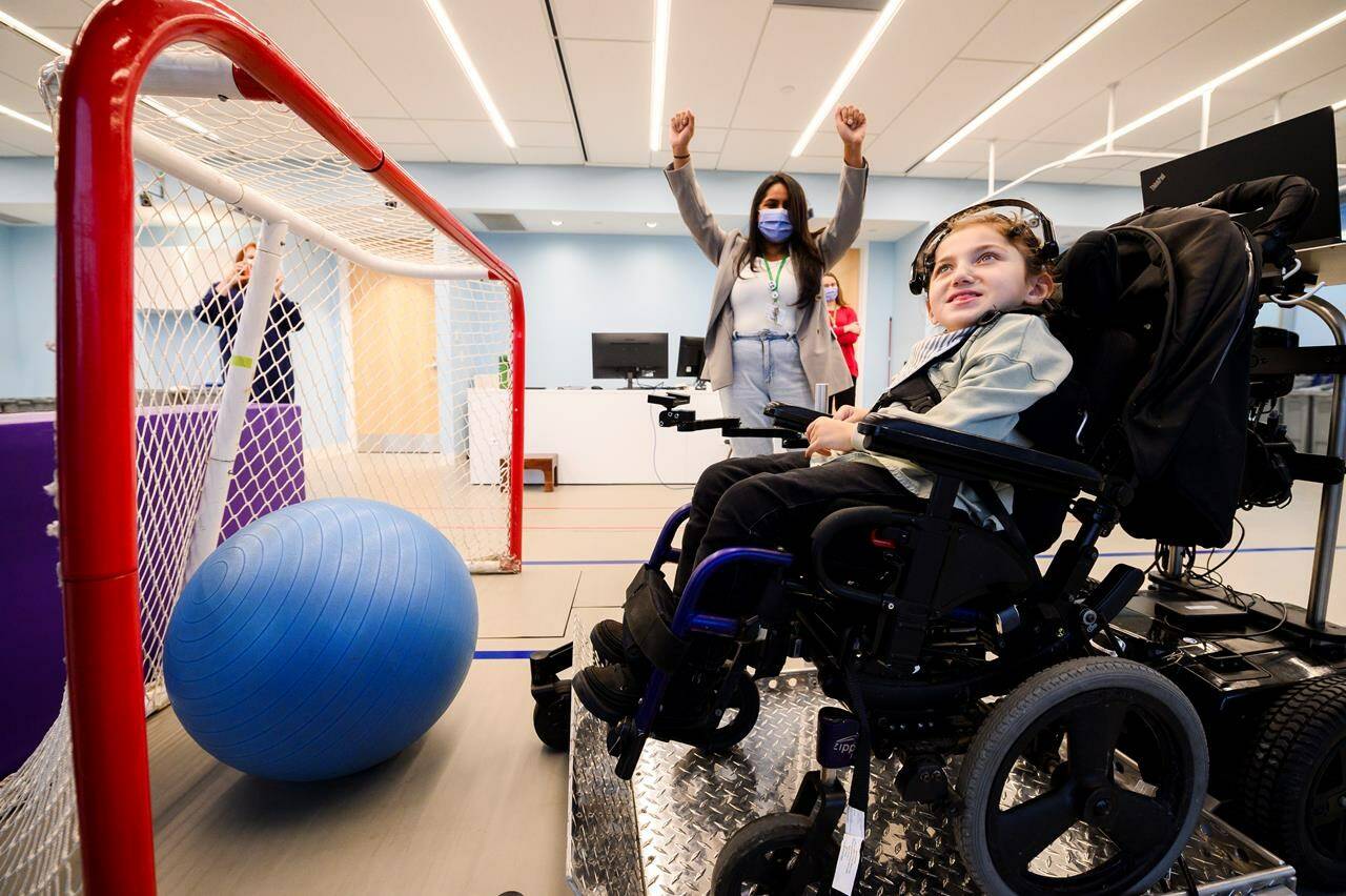 Brain-computer interface technology allows eight-year-old Giselle Alnaser to use her brain waves to move her wheelchair and play at the Holland Bloorview Kids Rehabilitation Hospital in Toronto, Tuesday, January 9, 2024. THE CANADIAN PRESS/Christopher Katsarov