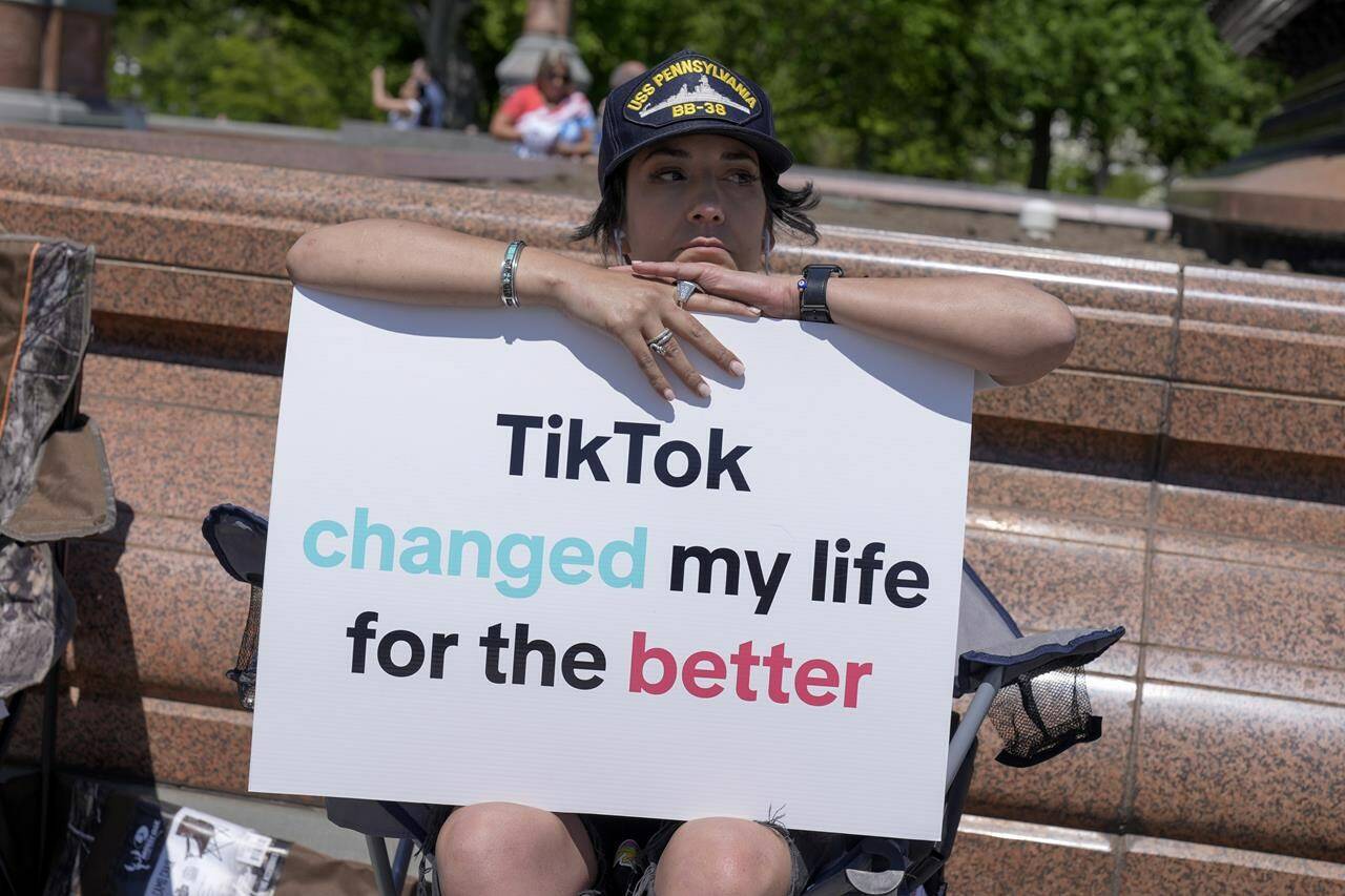 A TikTok content creator, sits outside the U.S. Capitol, Tuesday, April 23, 2024, in Washington as Senators prepare to consider legislation that would force TikTok’s China-based parent company to sell the social media platform under the threat of a ban, a contentious move by U.S. lawmakers. (AP Photo/Mariam Zuhaib)