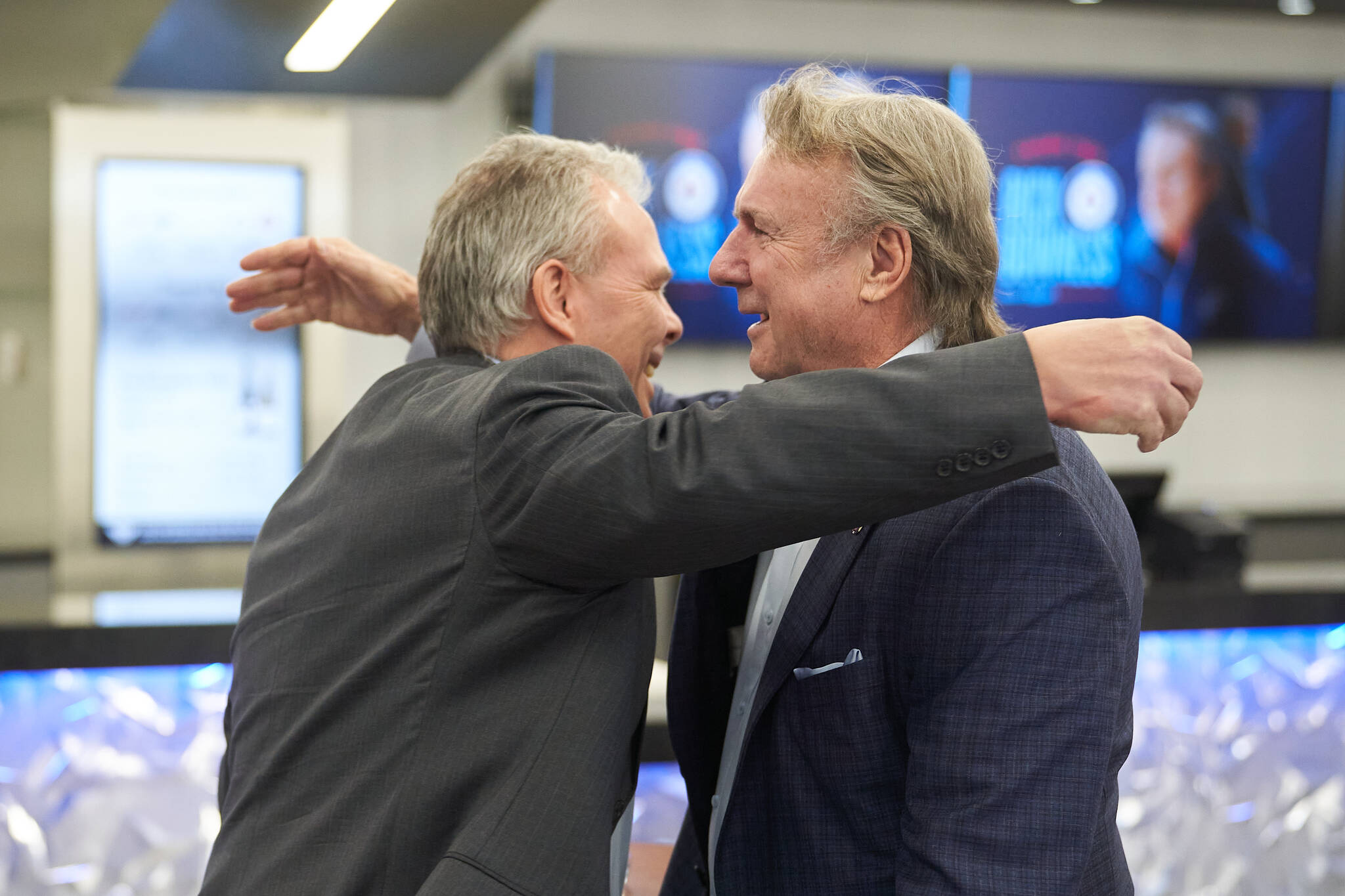 Winnipeg Jets General Manager Kevin Cheveldayoff, left, embraces former Jets head coach Rick Bowness after a press conference in which Bowness announced his retirement in Winnipeg on Monday, May 6, 2024. Bowness announced his retirement after 38 NHL seasons, a well-respected career that included leading the Dallas Stars to the Stanley Cup Final in 2020 and more time spent behind the bench than anyone else in league history. THE CANADIAN PRESS/David Lipnowski